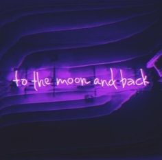 the words to the moon and back are lit up in purple neon lights against a black background