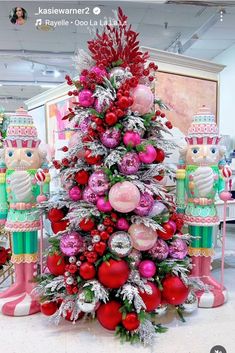 a christmas tree decorated with pink and red ornaments