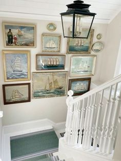 a stairway with pictures and paintings on the wall