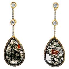 These brand-new Moss Agate Gemstone Diamond Drop Earrings in 18 karat white gold showcase the natural beauty of moss agate, with its unique earthy patterns, elegantly framed by sparkling diamonds. The earrings feature 2.21 carats of round brilliant-cut diamonds, adding a touch of luxury and brilliance. The diamonds are graded G-H color and VS clarity. Measuring 2.25 inches in length, these earrings offer a refined yet organic aesthetic, blending natural gemstones with the elegance of diamonds for a sophisticated, eye-catching accessory. Perfect for those who appreciate distinctive and luxurious designs. Weight: 15 grams. Earthy Patterns, Gold Diamond Drop Earrings, White Gold Drop Earrings, Yellow Gold Drop Earrings, Gray Gemstones, Organic Aesthetic, Yellow Quartz, White Gold Sapphire, Champagne Diamond