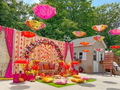 an outdoor wedding setup with pink and yellow umbrellas