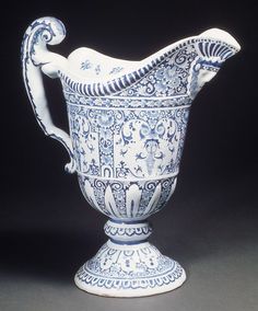 an ornate blue and white vase on a black background