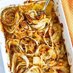 a casserole dish filled with onions and cheese