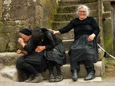 two older people sitting on steps with their arms around each other