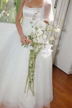 a woman in a wedding dress holding a bouquet