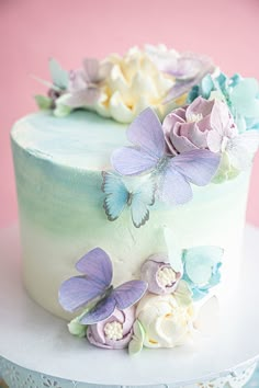 there is a cake decorated with flowers and butterflies