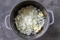 rice and other ingredients in a pot on a table