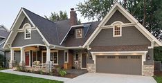 a gray house with white trim and two car garages