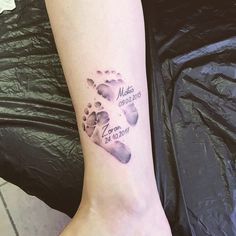 a woman's foot with a tattoo on it that reads, mom and son