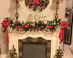 a fireplace decorated for christmas with wreaths and decorations