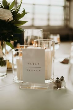 the table is set with candles and place cards