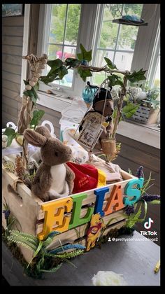 a wooden crate filled with stuffed animals and letters