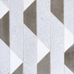 a white and grey tiled wall with different shapes