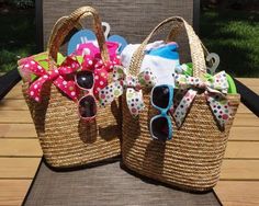 two straw bags with sunglasses and bows on them