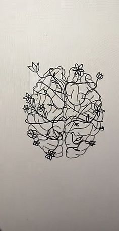 a drawing of flowers on the side of a white wall with black lines in it