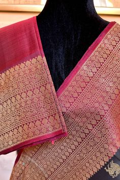 This banarasi inspired stunning kanjivaram saree in kanchana black is handwoven with traditional motifs in gold zari on the body. The borders in deep maroon have traditional motifs like floral, chakras and geometric patterns in gold zari. The grand pallu in deep maroon color mirrors the patterns of the borders in gold zari. Approximate Length 6.5 mtrs (inclusive of blouse length) Approximate weight - 1.5 lbs Approximate Height - 48 - 52" Saree comes with fall, picot and tassels done when applicable. Blouse piece is cut. Kindly Note : The colors you see on your device may vary due to the color reproduction, brightness and resolution of individual devices. If you'd like more clarity before your purchase, please contact our support team. Traditional Pre-draped Saree With Border, Traditional Festive Pre-draped Saree With Border, Black Silk Handloom Pre-draped Saree, Black Pre-draped Saree With Zari Weaving For Puja, Black Bollywood Handloom Pre-draped Saree, Gold Saree With Zari Weaving For Rituals, Black Art Silk Pre-draped Saree With Zari Weaving, Diwali Rituals Pre-draped Saree With Zari Weaving, Pre-draped Saree With Zari Weaving For Rituals