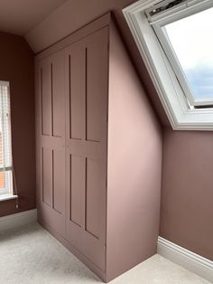 an empty room with pink painted walls and white trim on the window sill is shown