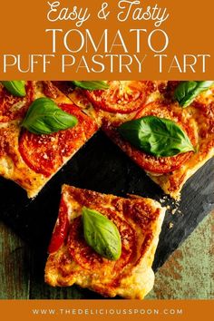 easy and tasty tomato puff pastry tart with basil leaves on top, sitting on a cutting board