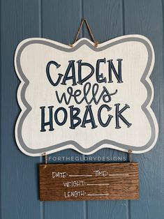 a sign that says garden we're hoback hangs on the wall next to a blue door