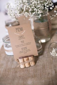 the table is set with wine corks and place cards for guests to write their names