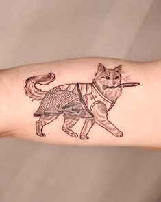 a cat tattoo on the arm of a person's arm with a hat and cane