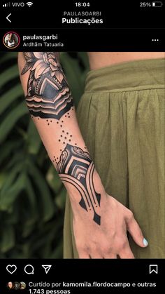 a woman's arm with a tattoo on it and an arrow in the middle