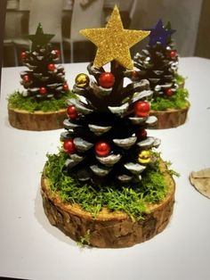 three pine cones with christmas decorations on them