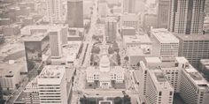 an aerial view of the city with tall buildings and skyscrapers in black and white