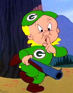 the green bay packers cartoon character is holding a baseball bat and looking at something in his hand