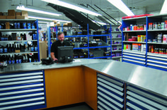 a man is working on his laptop at the store's checkout counter,