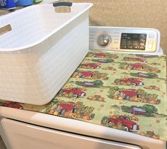 a washer and dryer sitting next to each other in a room with wallpaper