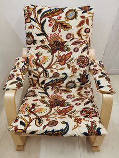 an upholstered chair with colorful fabric on it