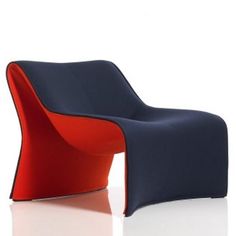 a blue and red chair sitting on top of a white floor