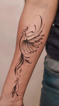 a woman's arm with a bird tattoo on it