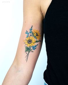 a woman with a sunflower tattoo on her arm