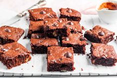 chocolate brownies are cut into squares on a tray