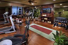 a home gym with treadmills and exercise equipment