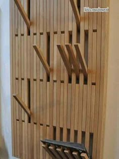 a chair sitting on top of a wooden floor next to a wall covered in wood slats