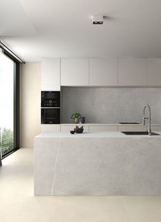 a modern kitchen with an island counter and sink