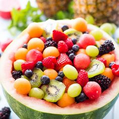 a watermelon filled with lots of different types of fruit