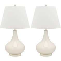 two white ceramic lamps with shades on them