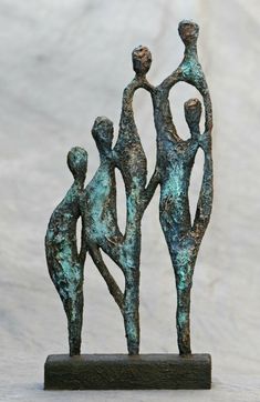 a bronze sculpture of three people holding hands