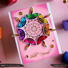 a pink card with colorful flowers on it