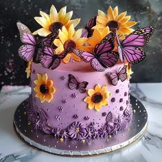 a purple cake with sunflowers and butterflies on it