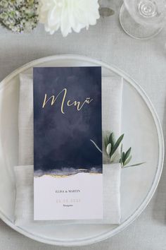 a table setting with place cards and napkins