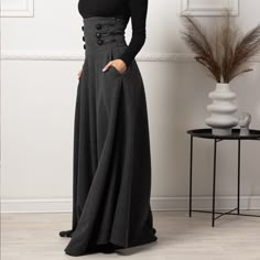 Elevate your winter wardrobe with our High Waisted Wool Maxi Skirt, crafted from luxurious cool wool for a sophisticated touch. This timeless piece features an extra-high waist adorned with stylish buttons, convenient pockets for added functionality, and a floor-length silhouette that effortlessly combines comfort and elegance, making it a versatile addition to any fashion-forward ensemble.  Enjoy the effortless fit and the feminine sense when wearing our creations! Every piece by NikkaPlace is Long Skirts With Pockets, Wool Clothing Women, Maxi Wool Skirt, Womens Gothic Fashion, Chic All Black Outfit, Highwaist Skirt, Floor Length Skirts, Stylish Buttons, Wool Clothes