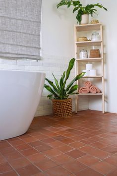 a bath room with a tub and a shelf