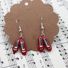 Dorothy's  red shoes earrings for pierced ears.All nickel free Comes in a pretty organza bag,Please feel free to ask any questions Wizard Of Oz Shoes, Dorothy Red Shoes, Dolly Shoes, Red Leather Shoes, Vintage Style Shoes, Dog Birthday Card, Red Vintage, Wizard Of Oz, Shoe Lover