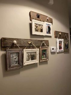 several frames are hanging on the wall with clothes pins