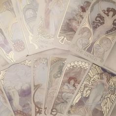 five cards with angels on them sitting next to each other